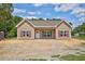 Charming single-story home with tan siding, red shutters, and a well-manicured lawn at 2820 Tara Dr, Clayton, NC 27520