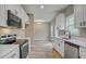 Bright kitchen area features stainless steel appliances, white cabinets, and a view into the dining room at 2820 Tara Dr, Clayton, NC 27520