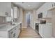 Modern kitchen with white cabinets, stainless steel appliances, and hardwood floors at 2820 Tara Dr, Clayton, NC 27520