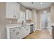 Modern kitchen with white cabinets, stainless steel appliances, and hardwood floors at 2820 Tara Dr, Clayton, NC 27520