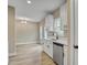 An open concept kitchen features stainless steel appliances and a view into the living area at 2820 Tara Dr, Clayton, NC 27520
