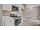 Kitchen area shows white cabinets, stainless appliances, quartz countertops, and an open floorplan at 2820 Tara Dr, Clayton, NC 27520