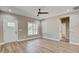 Spacious living room with hardwood floors, neutral walls, ceiling fan, and ample natural light at 2820 Tara Dr, Clayton, NC 27520