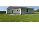 Backyard view of home with grassy area and exterior door at 299 Phil Jack Rd, Dunn, NC 28334