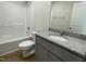 Bathroom featuring a combination tub and shower, gray vanity with granite countertop, and a mirrored backsplash at 299 Phil Jack Rd, Dunn, NC 28334