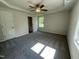 Bright bedroom featuring a ceiling fan, large window, and plush carpeting at 299 Phil Jack Rd, Dunn, NC 28334