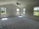 Large bonus room featuring large windows and plush gray carpeting at 299 Phil Jack Rd, Dunn, NC 28334
