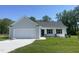 Charming single-story home with gray siding, white trim, and a two-car garage, nestled on a lush green lot at 299 Phil Jack Rd, Dunn, NC 28334