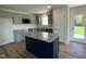 Modern kitchen with gray cabinets, granite counters, stainless steel appliances, and a center island at 299 Phil Jack Rd, Dunn, NC 28334