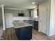 Modern kitchen with gray cabinets, granite counters, stainless steel appliances, and a center island at 299 Phil Jack Rd, Dunn, NC 28334