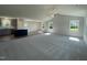 Bright open-concept living space with neutral paint, modern ceiling fan and hardwood and carpet flooring at 299 Phil Jack Rd, Dunn, NC 28334