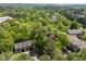 Scenic aerial view of townhomes nestled among lush trees, offering a serene and private community setting at 300 Nc 54 # E3, Carrboro, NC 27510