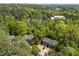 A high angle aerial view of the townhomes reveals the surrounding lush trees and parking at 300 Nc 54 # E3, Carrboro, NC 27510