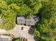 An aerial view captures this beautiful townhome, with its parking and a surrounding tree canopy at 300 Nc 54 # E3, Carrboro, NC 27510