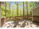 Inviting outdoor deck surrounded by lush trees, offering a serene escape in a natural setting at 300 Nc 54 # E3, Carrboro, NC 27510