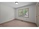 Bedroom with neutral carpet, window and white walls at 300 Nc 54 # E3, Carrboro, NC 27510