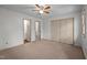 Bedroom with neutral carpet, standard closet, ceiling fan and open bathroom door at 300 Nc 54 # E3, Carrboro, NC 27510