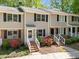 Charming townhome featuring black shutters, brick accents, and a beautifully landscaped entrance at 300 Nc 54 # E3, Carrboro, NC 27510