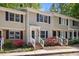 Charming townhome featuring a classic design and colorful flowers in the front yard at 300 Nc 54 # E3, Carrboro, NC 27510
