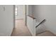 Bright hallway with neutral carpet, white walls and wood trim on banister at 300 Nc 54 # E3, Carrboro, NC 27510