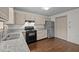 Modern kitchen featuring granite countertops, stainless steel appliances, and sleek, neutral cabinets at 300 Nc 54 # E3, Carrboro, NC 27510