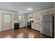 Updated kitchen with stainless steel appliances, granite countertops, and modern cabinetry at 300 Nc 54 # E3, Carrboro, NC 27510