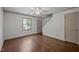 Cozy living room with hardwood floors, a ceiling fan, and a window, offering comfort and convenience at 300 Nc 54 # E3, Carrboro, NC 27510