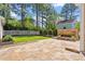 Outdoor patio area featuring stone pavers and a brick fireplace at 30038 Village Park Dr, Chapel Hill, NC 27517
