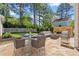Outdoor patio area featuring a dining table, ample seating and a built-in fireplace at 30038 Village Park Dr, Chapel Hill, NC 27517