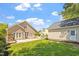 Expansive backyard featuring a lush lawn and a stone patio with white fence at 30038 Village Park Dr, Chapel Hill, NC 27517