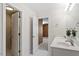 Bright, neutral bathroom with double sinks, white cabinets, and a separate shower room at 30038 Village Park Dr, Chapel Hill, NC 27517