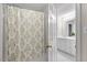 Bright bathroom featuring a shower with decorative curtain and white cabinets at 30038 Village Park Dr, Chapel Hill, NC 27517