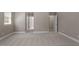 Bedroom with carpet flooring, neutral walls, and multiple doorways, showcasing the home's layout at 30038 Village Park Dr, Chapel Hill, NC 27517