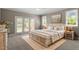 Serene bedroom with a cozy bed, soft lighting, and glass doors that open to the outdoors at 30038 Village Park Dr, Chapel Hill, NC 27517