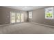 Bedroom with carpet flooring, glass doors, and a window that provides natural light at 30038 Village Park Dr, Chapel Hill, NC 27517