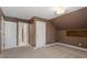 Cozy bedroom with neutral carpet, brown walls, and two closet doors at 30038 Village Park Dr, Chapel Hill, NC 27517