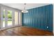 Dining room with an accent wall, hardwood floors, and glass doors with backyard views at 30038 Village Park Dr, Chapel Hill, NC 27517