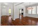 Spacious dining room featuring hardwood floors, columns and french doors leading into another living space at 30038 Village Park Dr, Chapel Hill, NC 27517