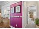 Hallway with art, hooks, and views of the kitchen and bedroom, enhancing the home's appeal at 30038 Village Park Dr, Chapel Hill, NC 27517