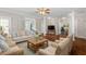 Spacious living room with hardwood floors, decorative columns, and an abundance of natural light at 30038 Village Park Dr, Chapel Hill, NC 27517