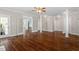 Spacious room featuring hardwood floors, columns and french doors leading into another living space at 30038 Village Park Dr, Chapel Hill, NC 27517