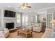Cozy living room featuring a fireplace, hardwood floors, and French doors leading to dining area at 30038 Village Park Dr, Chapel Hill, NC 27517