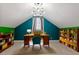 Bright office featuring a sloped ceiling, modern light fixture, and custom wood shelving at 30038 Village Park Dr, Chapel Hill, NC 27517
