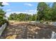 Community playground with swings and play structures set in a wooded area at 30038 Village Park Dr, Chapel Hill, NC 27517