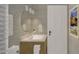 Stylish bathroom with a round mirror, modern lighting, and stone-look wall at 307 Burke St, Dunn, NC 28334