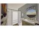 Bathroom featuring a shower with a modern vanity and a decorative round mirror at 307 Burke St, Dunn, NC 28334
