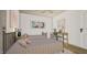 Bright bedroom with two beds, artwork and a study desk area with a chair and a lamp at 307 Burke St, Dunn, NC 28334