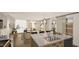 Kitchen with a center island featuring a stainless steel sink and stylish hardware, with an open living space at 307 Burke St, Dunn, NC 28334