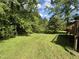 Green backyard with a deck adding an extension to this property at 311 N Nash St, Hillsborough, NC 27278