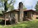Brick home with a wooden deck and backyard access, surrounded by a lush green lawn at 311 N Nash St, Hillsborough, NC 27278